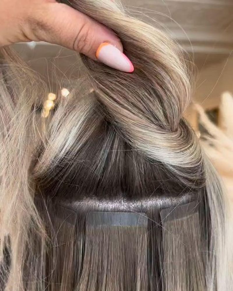 A thin pre-taped weft sandwiched around a section of natural hair