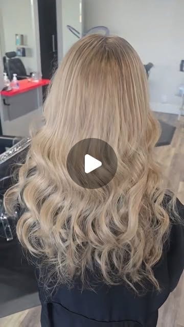 A blonde retouch finished in long, loose waves